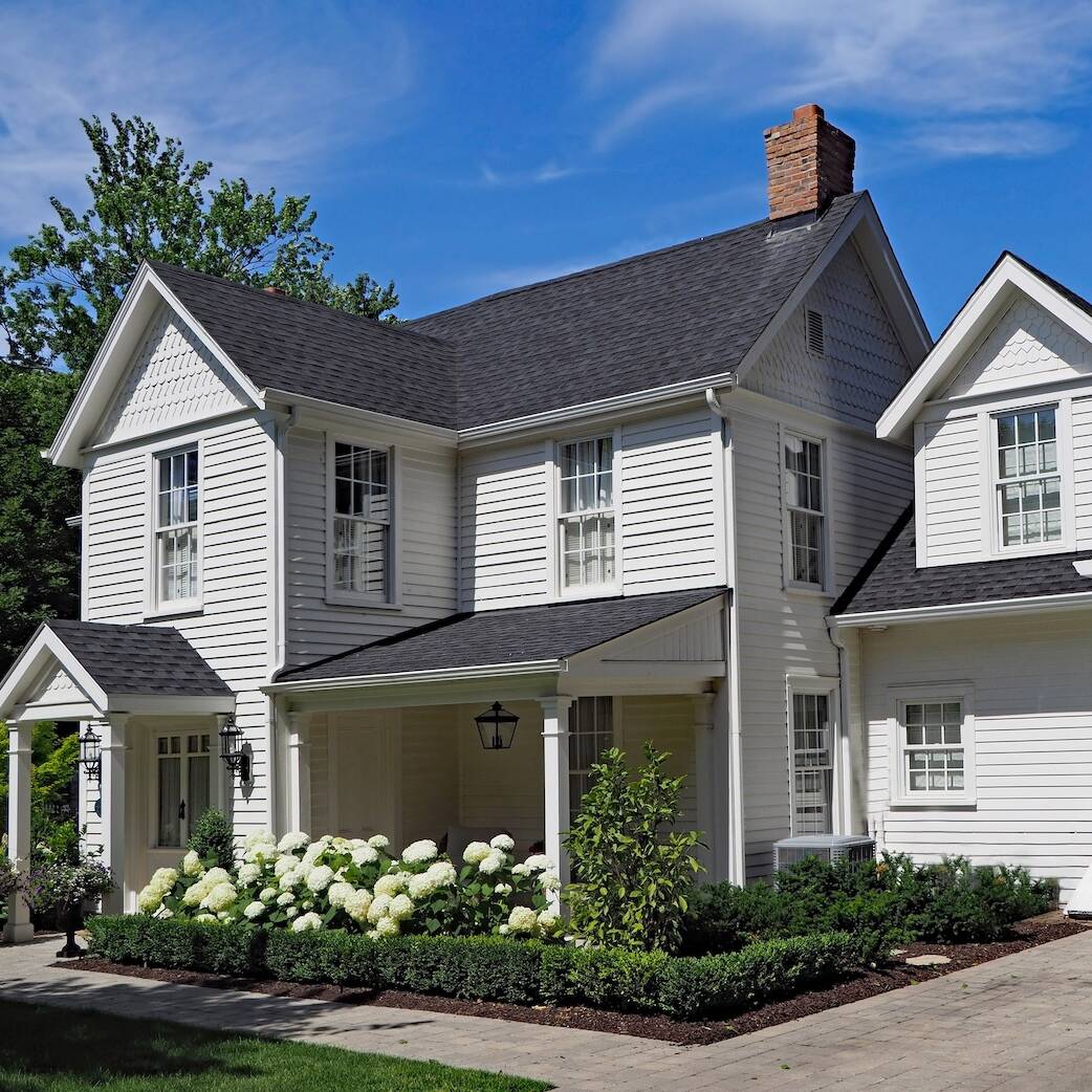 white clapboard house with gable and portico entrance