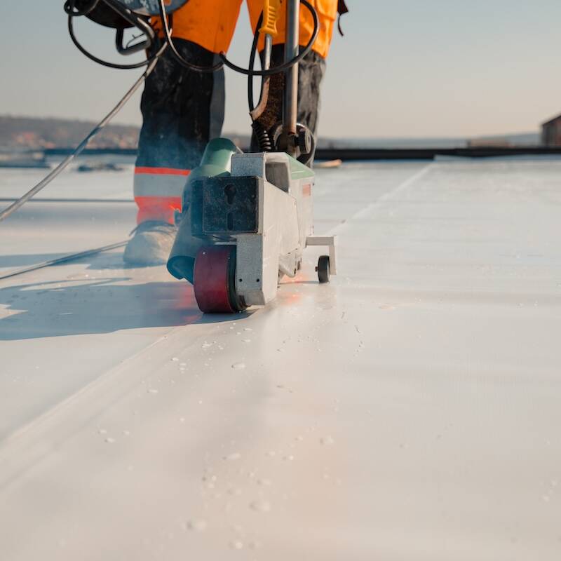 Waterproofing and insulation at construction site, waterproofing membrane preventing water penetration. Exterior vapor barrier for roof.