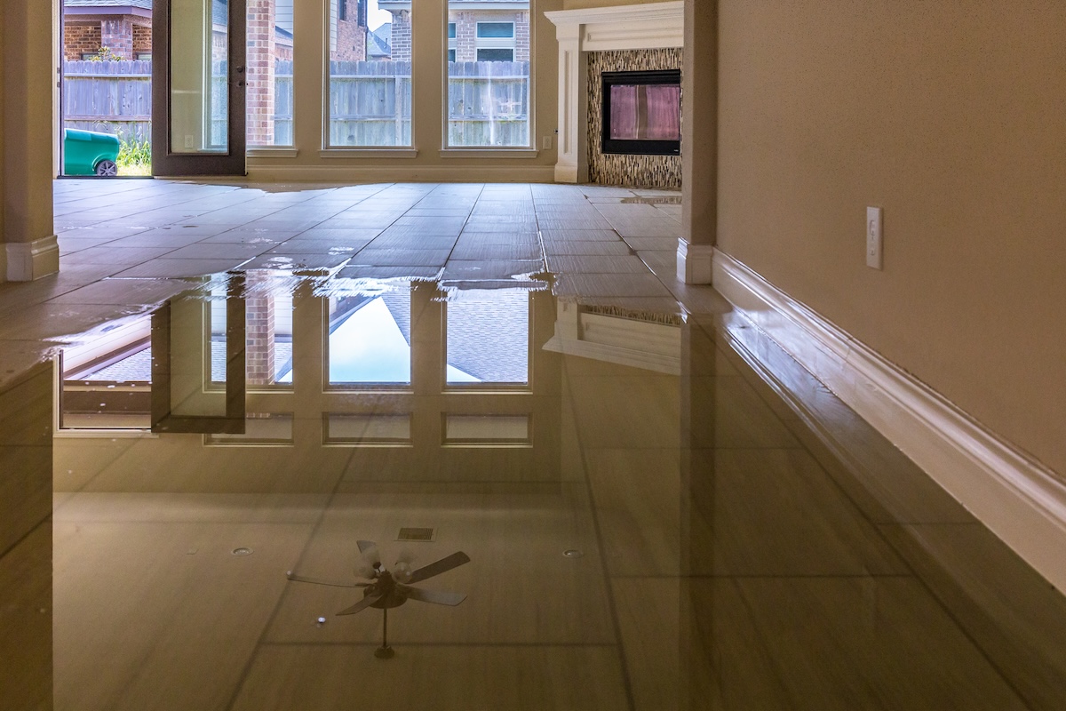 Flooded living room with water covering the floor,